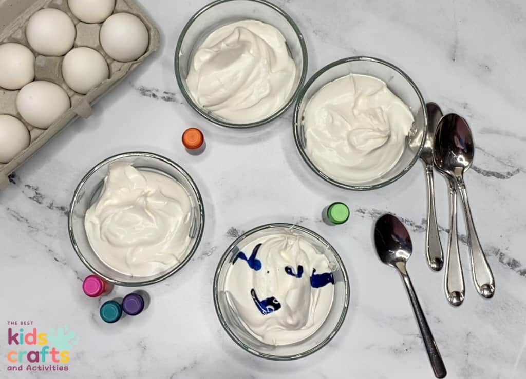 Whipped Cream Dyed Easter Egg supplies - bowls with whipped cream, food coloring, spoons and hard boiled eggs