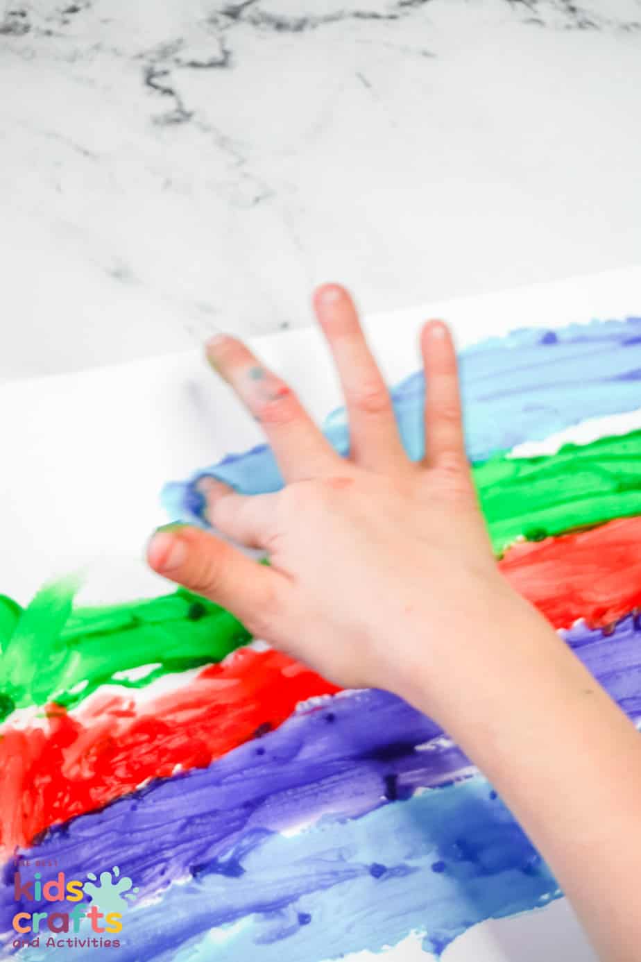 kid painting with homemade finger paint