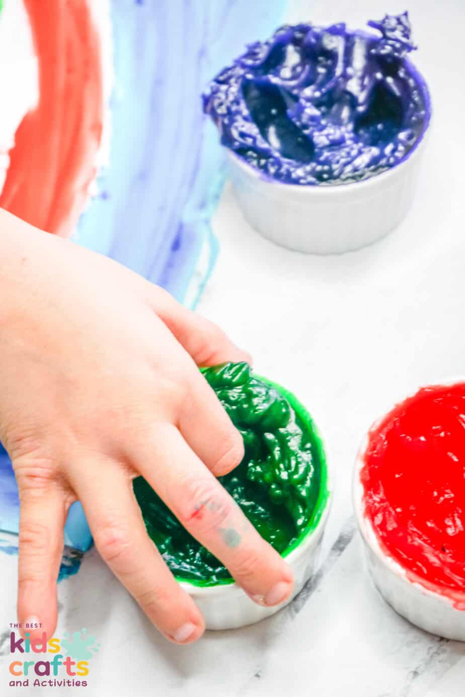 child's hand using homemade finger paint