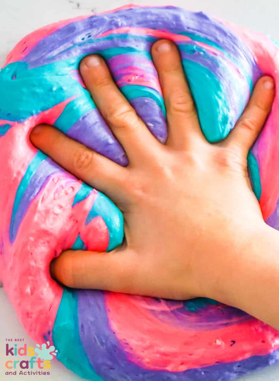 kids hand playing with Fluffy Unicorn Slime Recipe