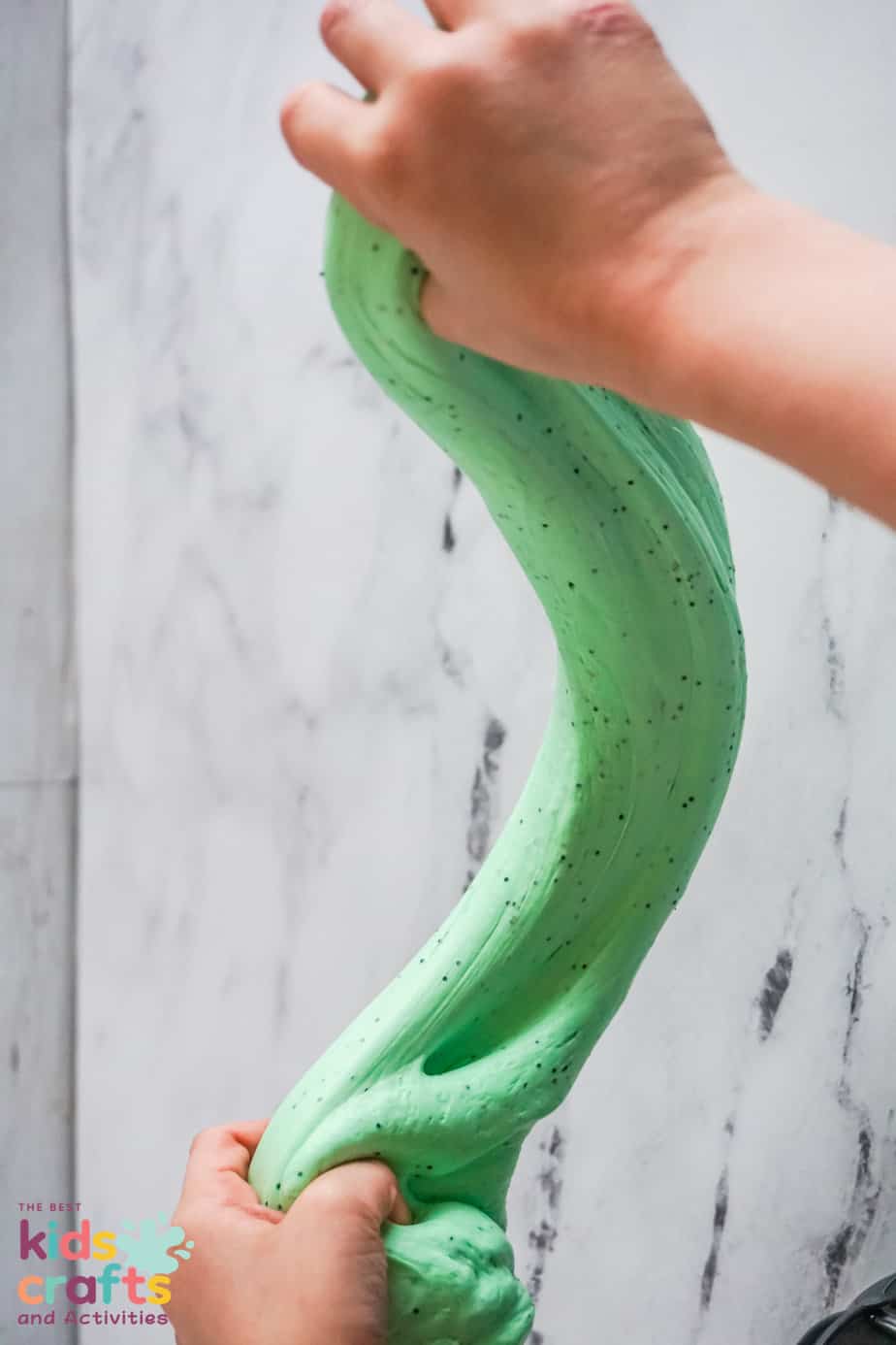 Halloween green butter slime  being stretched out
