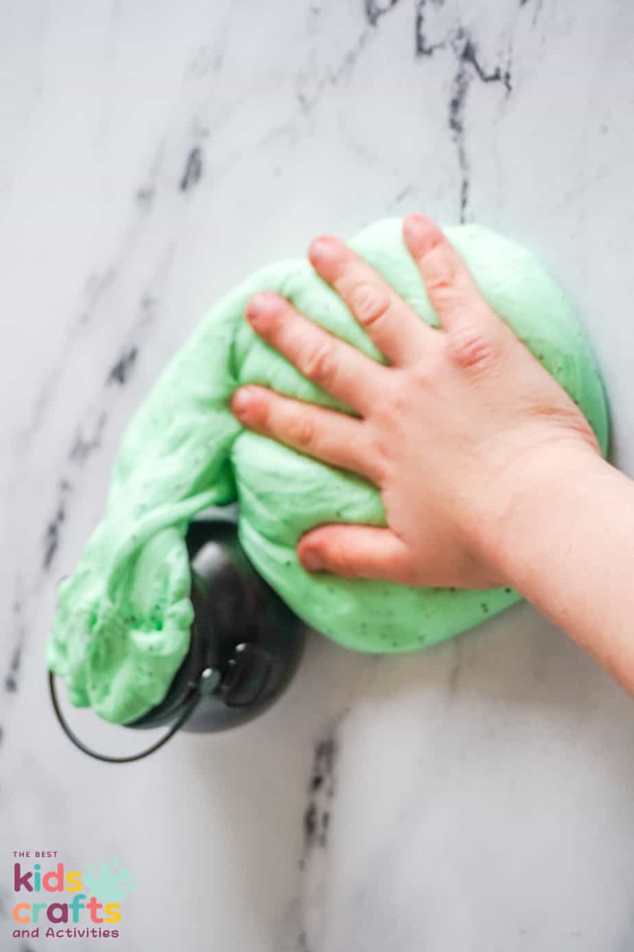 Halloween green butter slime  with kids hand playing with it